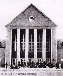 front view of the Festhalle in Hellerau displaying the yin-yang symbol of "Dalcroze's Eye" on the pediment